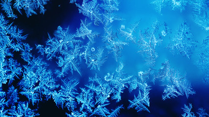Fototapeta na wymiar Frosted frozen window abstract background. Winter season Christmas ornament dark blue ice window decoration wallpaper