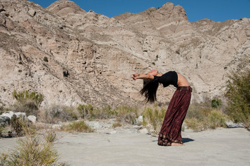 Woman in a beautiful backbend in the desert. 