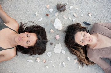 Two Wild Women meditating with crystals in a desert nature wilderness. 