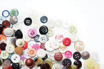 Obraz na płótnie Canvas Multi-colored sewing buttons of different sizes and shapes on an isolated background 