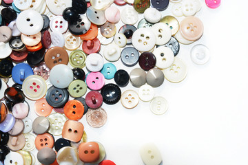 Multi-colored sewing buttons of different sizes and shapes on an isolated background 