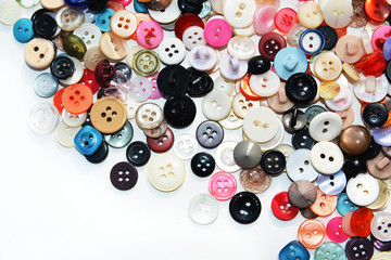 Multi-colored sewing buttons of different sizes and shapes on an isolated background 