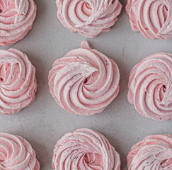 Meringue zephyr marshmallows lined up in a square on a light background. flat ley. Pink sweet homemade marshmallow. meringue on white background.