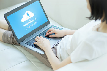 Woman trying to Cloud Downloading on laptop