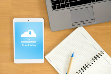 top view of business workspace to cloud uploading , notebook and female hands typing on keyboard