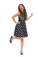 Carefee Woman In High Heels And Black Cocktail Dress Is Dancing On One Leg