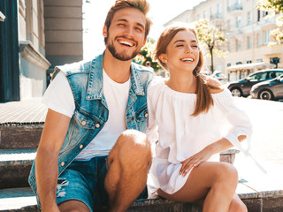 Smiling beautiful girl and her handsome boyfriend. Woman in casual summer dress and man in jeans...