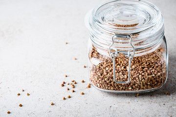 Uncooked buckwheat in jar.