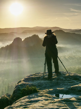 Woman nature art photographer works.  Takes photo in nature