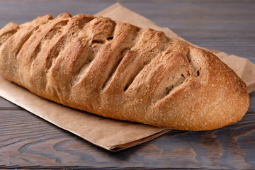 Bread with bran on wooden an old wooden table. Homemade bread