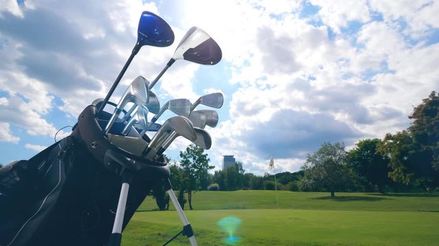 Many golf clubs in one bag on a field.