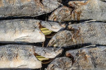Thai street vendor sells grilled fish at street market in Koh Phangan, Thailand. Close up
