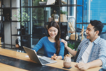 Two Asian people working together.