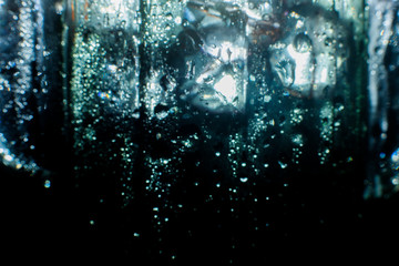Easy to add lens flare effects for overlay designs or screen blending mode to make high-quality images. Abstract sun burst, digital flare, iridescent glare over black background. Drops on glass.
