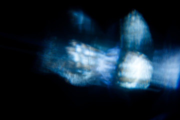 Lens Flare. Light over black background. Easy to add overlay or screen filter over photos. Abstract sun burst with digital lens flare background. Gleams rounded and hexagonal shapes, rainbow halo.