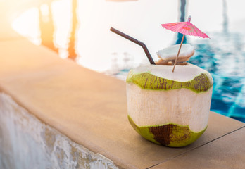 Fresh coconut drink at the swimming pool in holidays.