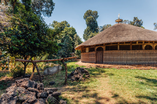 The hut shape UNESCO Monastery Azwa Maryam, church dedicated for the memorial of saint Merry, Bahir Dar, lake Tana Ethiopia. in front of church is stone bell