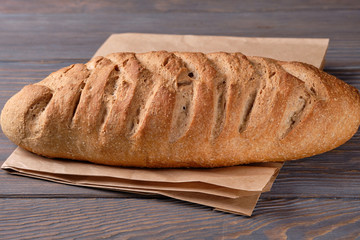 Bread with bran on wooden an old wooden table. Homemade bread