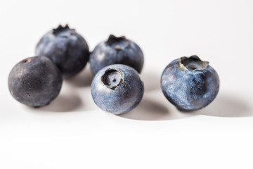 Many red and white berry.Good tasting blueberries with full of healthy vitamins..A good vegan meal. Set of tasty blueberries on white background, closeup.