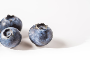 Many red and white berry.Good tasting blueberries with full of healthy vitamins..A good vegan meal. Set of tasty blueberries on white background, closeup.