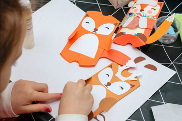 Children make Christmas crafts. Child art project. Kids hands makes paper craf. Christmas crafts for children.DIY concept.