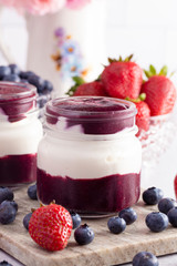 Yogurt and Berry Puree in a Glass Jar for Breakfast