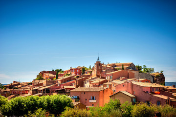 Fototapeta na wymiar The small village of Roussillon. Landscape with houses in historic ocher village Roussillon, Provence, Luberon, Vaucluse, France