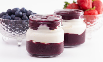 Yogurt and Berry Puree in a Glass Jar for Breakfast