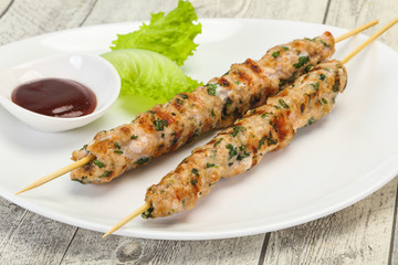 Minced pork skewer kebab with sauce