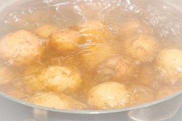 New potatoes boil in their skins in a saucepan