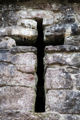 Crucifix murder hole in wall