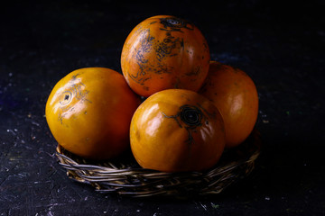 Persimmons. Persimmon fruits in basket.