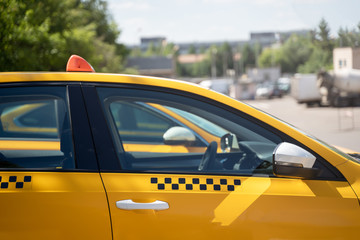 Photo of yellow taxi on street in summer