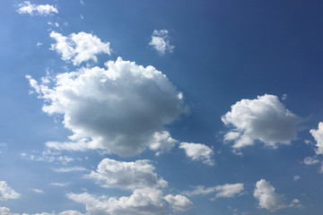 Naklejka na ściany i meble Beautiful clouds against a blue sky background. Cloud sky. Blue sky with cloudy weather, nature cloud. White clouds, blue sky and sun