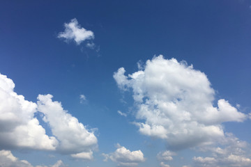 Naklejka na ściany i meble Beautiful clouds against a blue sky background. Cloud sky. Blue sky with cloudy weather, nature cloud. White clouds, blue sky and sun