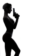 sexual strong well-built model holding a gun and posing to the camera. close up side view photo. copy space