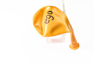 deflated balloon, the ego is written on the balloon