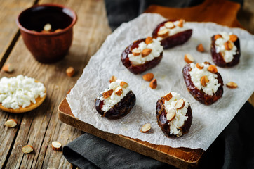 Almond and goat cheese stuffed dates with glasses of wine