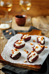 Almond and goat cheese stuffed dates with glasses of wine