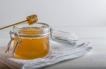 fresh honey drains from spoonfuls for honey