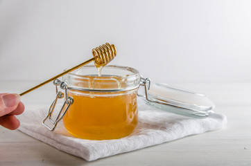 fresh honey drains from spoonfuls for honey