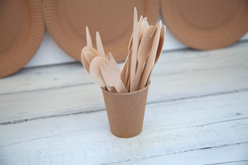 Fototapeta na wymiar natural disposable eco ware from cardboard paper knife wood cup