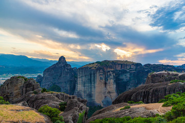 Wonderful view of the rocks of Meteora, Greece. Mysterious Sunny evening with colorful sky, during sunset. Awesome Nature Landscape. Amazing Greece. Popular travel locations