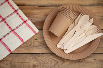 Disposable tableware from natural materials, wooden knife, spoon, fork, environmentally friendly. Ecological dishes in nature. Place for text.
