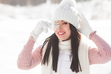 Close up portrait of young beautiful woman with snowflake