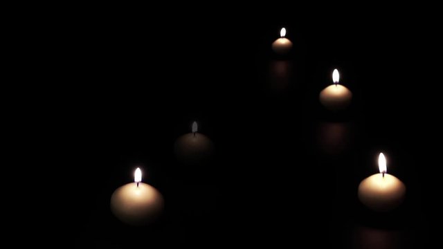 Candles Light Up And Disappear shows many candles appearing and lighting up on a dark background. The appearing candles symbolize hope and unity. 