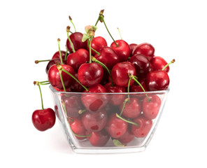Ripe red cherries in bowl on white. Background isolated
