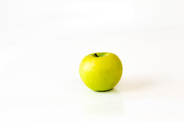 green apple on white ground