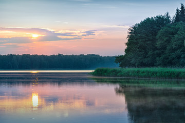 Fototapeta na wymiar Sunrise over Szarek Lake. Masuria. Poland.