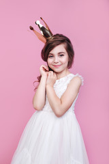 Little cute princess girl in gold crown and beautiful dress on pink background © Elena Kratovich